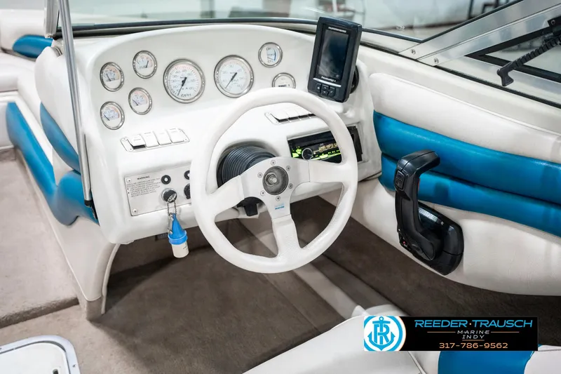 Slide: The Image of Interior of 1995 Crownline 182 BR boat with steering wheel and dashboard controls. - 28