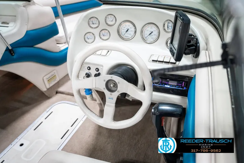 Slide: The Image of Interior of a 1995 Crownline 182 BR boat, featuring steering wheel and dashboard controls. - 30