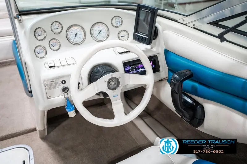 Slide: The Image of 1995 Crownline 182 BR boat dashboard with steering wheel and gauges. - 31