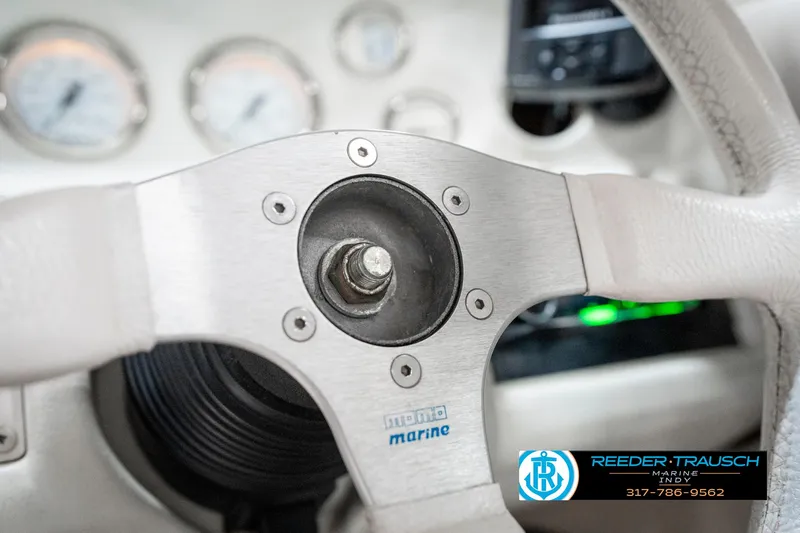 Slide: The Image of Steering wheel of a 1995 Crownline 182 BR boat, featuring a Momo Marine hub. - 32