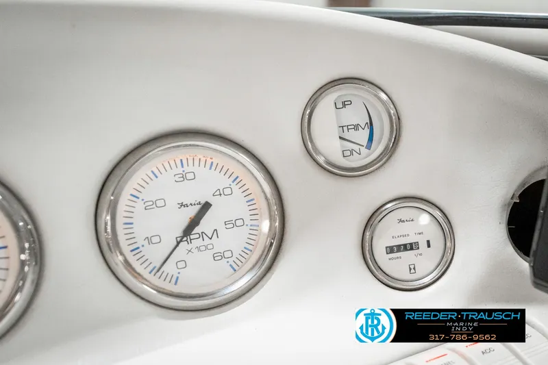 Slide: The Image of Dashboard gauges of a 1995 Crownline 182 BR boat, featuring RPM and trim indicators. - 35