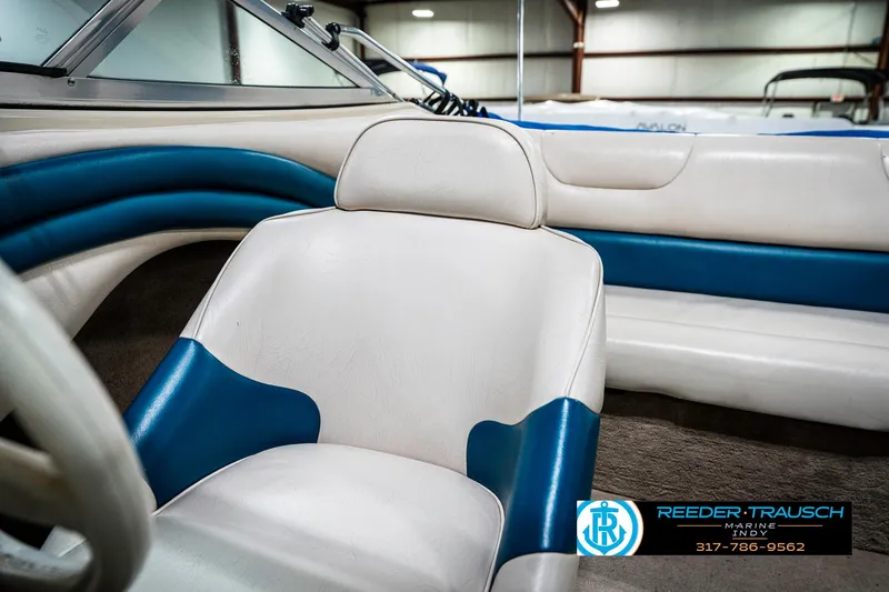 Slide: The Image of Interior of a 1995 Crownline 182 BR boat with white and blue seating. - 40