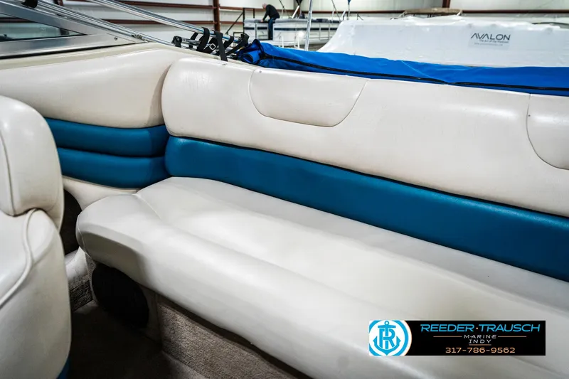 Slide: The Image of Interior seating of 1995 Crownline 182 BR boat, featuring white and blue upholstery. - 42