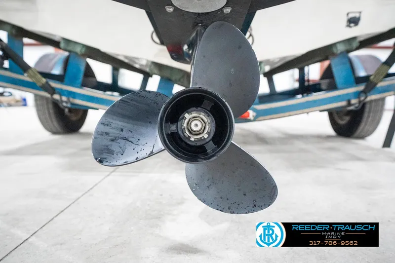 Slide: The Image of 1995 Crownline 182 BR boat propeller with trailer in a garage setting. - 48