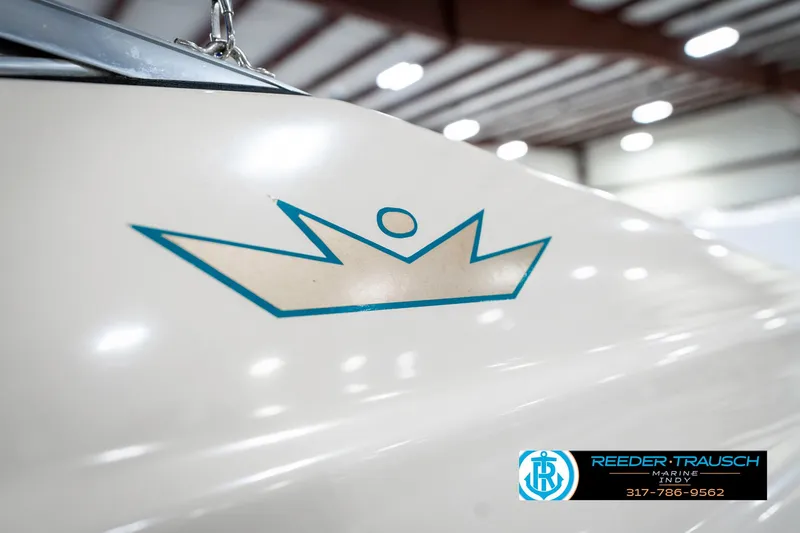 Slide: The Image of 1995 Crownline 182 BR boat with crown logo in indoor setting. - 49