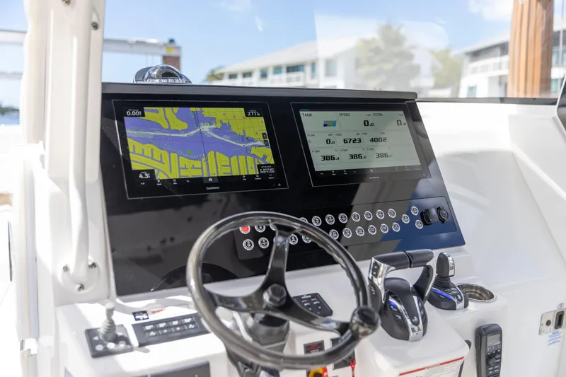 Slide: The Image of Edgewater 370CC 2023 boat dashboard with navigation screens and controls. - 1