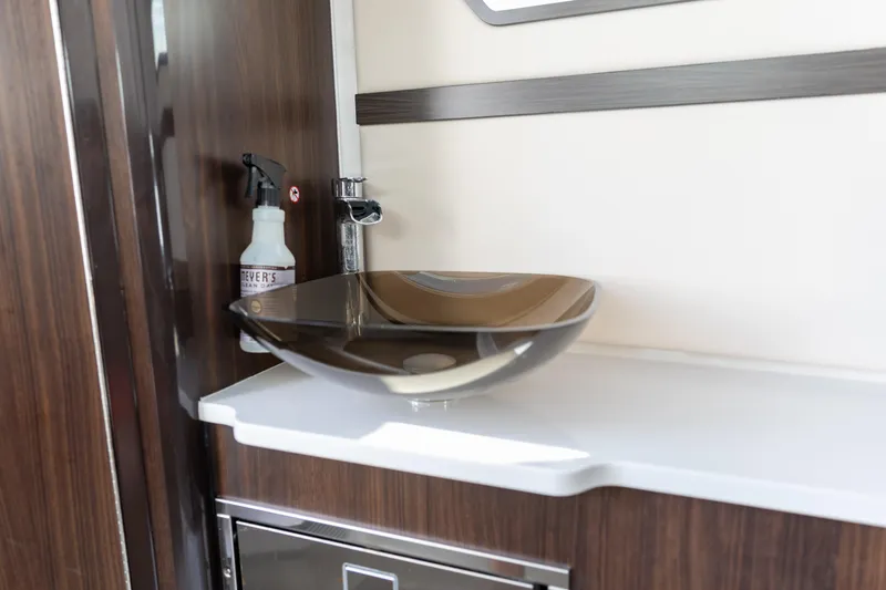 Slide: The Image of Modern sink area in 2023 Edgewater 370CC boat with sleek design and wood accents. - 17