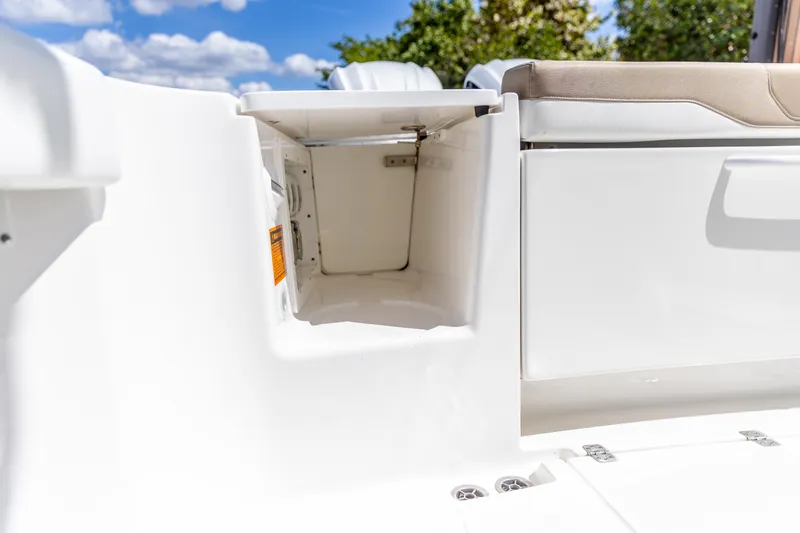 Slide: The Image of 2023 Edgewater 370CC boat storage compartment with open hatch, white interior, and cushioned seating. - 21