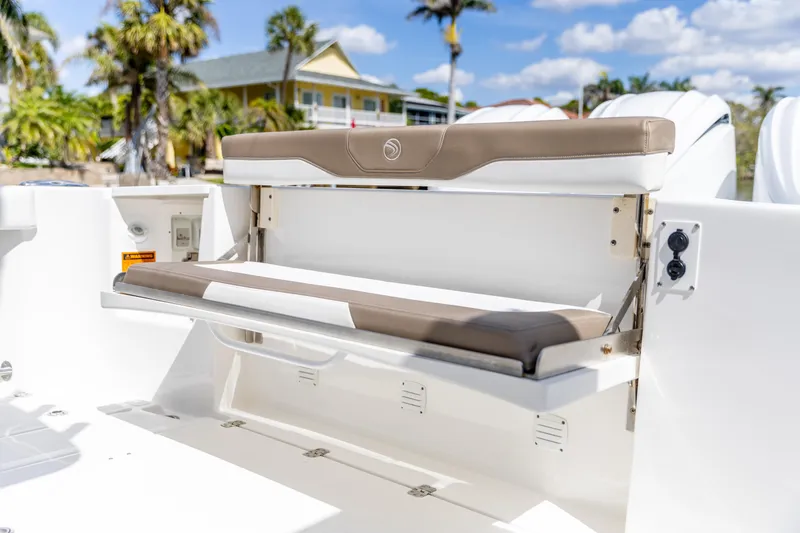 Slide: The Image of 2023 Edgewater 370CC boat with foldable seating, tropical background. - 23