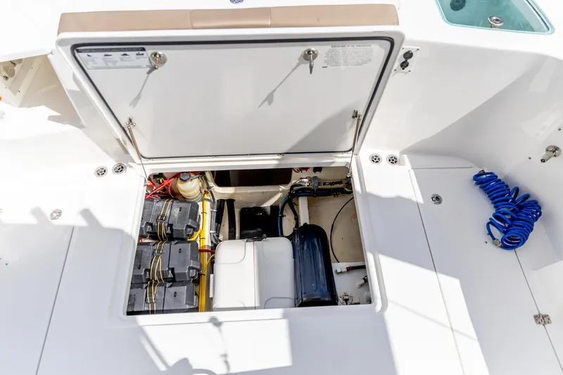 Slide: The Image of 2023 Edgewater 370CC boat storage compartment with batteries and equipment. - 26