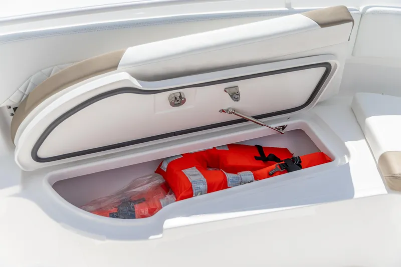 Slide: The Image of Storage compartment with life jackets on 2023 Edgewater 370CC boat. - 27
