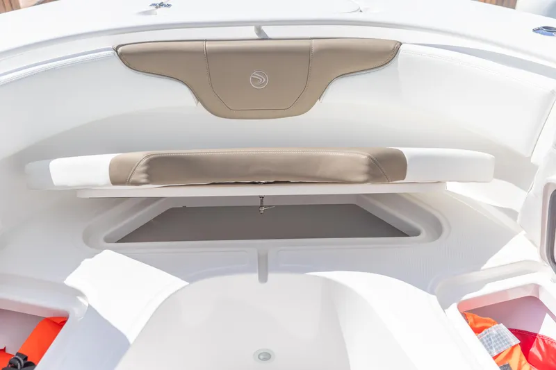 Slide: The Image of 2023 Edgewater 370CC boat interior with cushioned seating and storage compartment. - 28