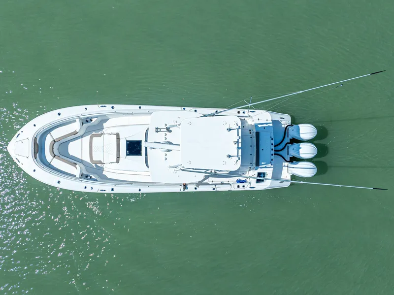 Slide: The Image of Aerial view of 2023 Edgewater 370CC boat on calm green water. - 32