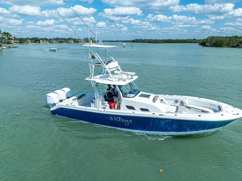 Slide: The Image of 2023 Edgewater 370CC boat cruising on a sunny day with clear skies. - 34