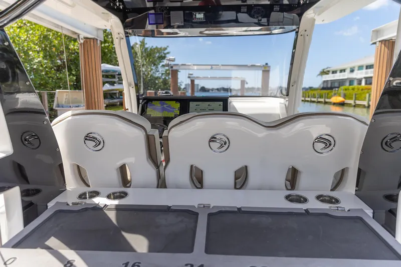 Slide: The Image of 2023 Edgewater 370CC boat interior with helm seats and navigation equipment. - 37