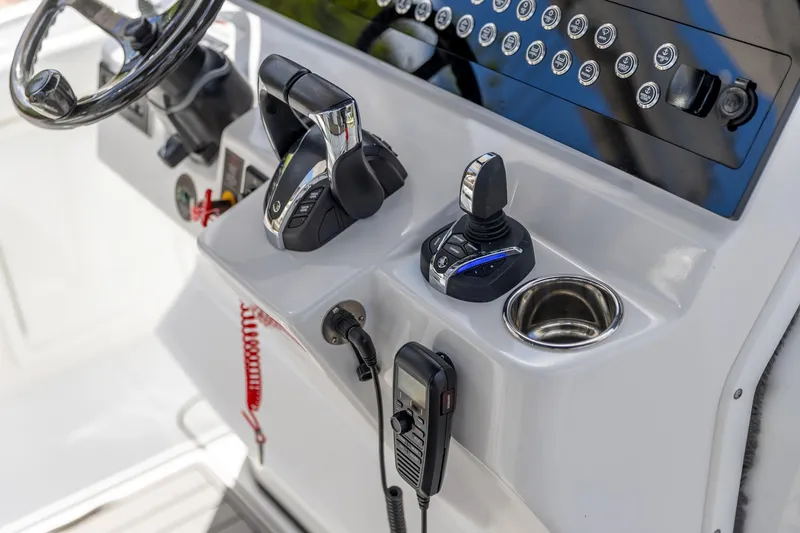 Slide: The Image of 2023 Edgewater 370CC boat controls and dashboard with steering wheel and communication devices. - 39