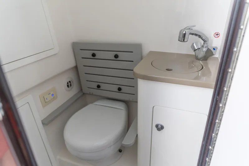 Slide: The Image of 2023 Edgewater 370CC boat bathroom with toilet and sink. - 6