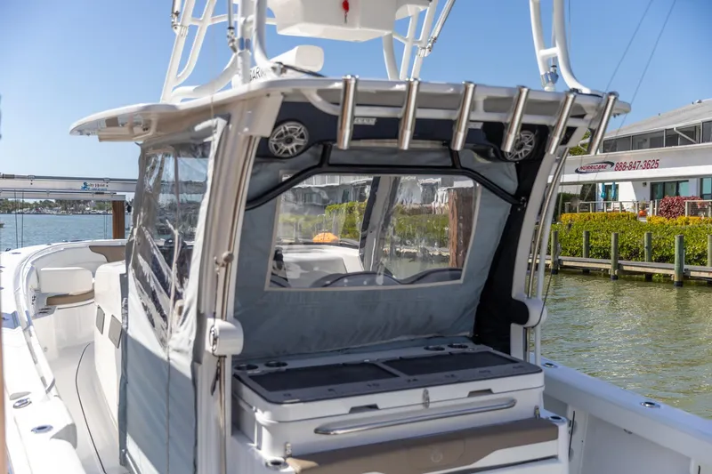 Slide: The Image of 2023 Edgewater 370CC boat docked, showcasing sleek design and modern features. - 7