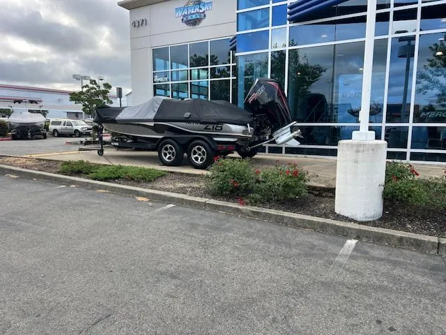 Slide: The Image of Covered Nitro Z18 Pro 2025 boat parked outside a dealership on a cloudy day. - 1