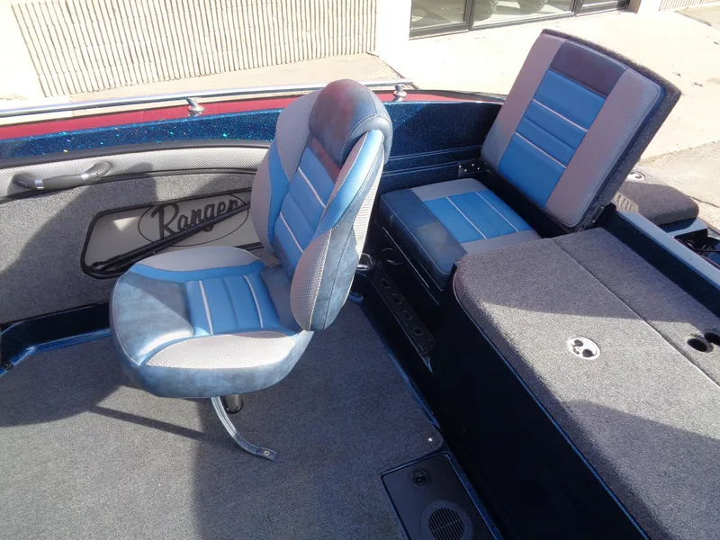 Slide: The Image of 2024 Ranger 1880MS boat interior with blue and gray seating. - 13