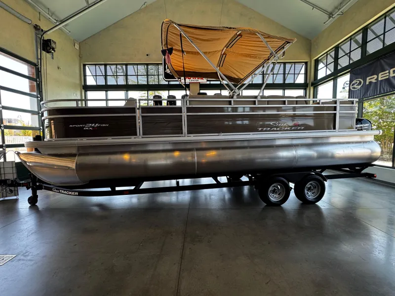 The Image of 2025 Sun Tracker Sportfish 24 XP3 pontoon boat in showroom, side view. - 0