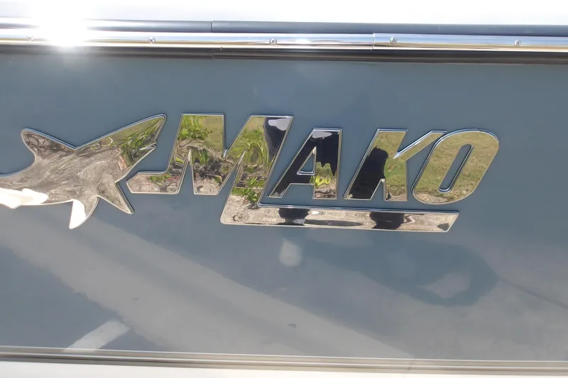 Slide: The Image of Chrome "Mako" logo on 2025 Mako 214 Center Console boat. - 19