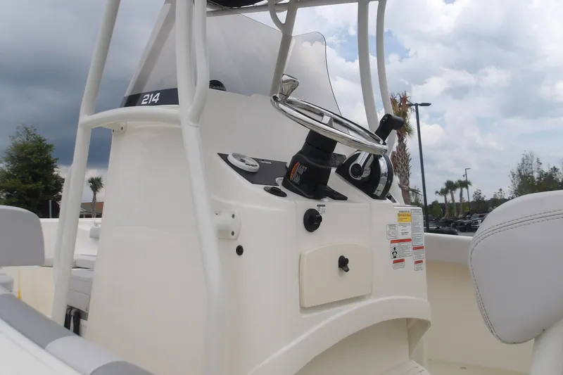 Slide: The Image of 2025 Mako 214 Center Console boat steering console under cloudy sky. - 15