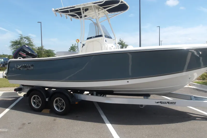 The Image of 2025 Mako 214 Center Console boat on trailer in parking lot. - 1