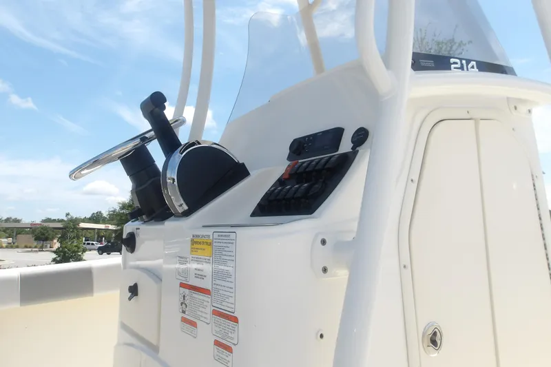 Slide: The Image of 2025 Mako 214 Center Console boat dashboard with steering wheel and control panel. - 11