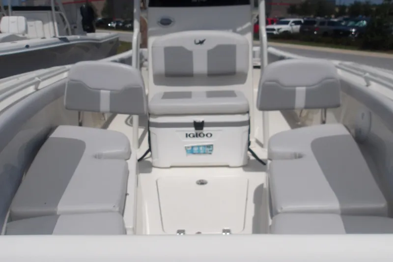Slide: The Image of 2025 Mako 214 Center Console boat interior with seating and Igloo cooler. - 14