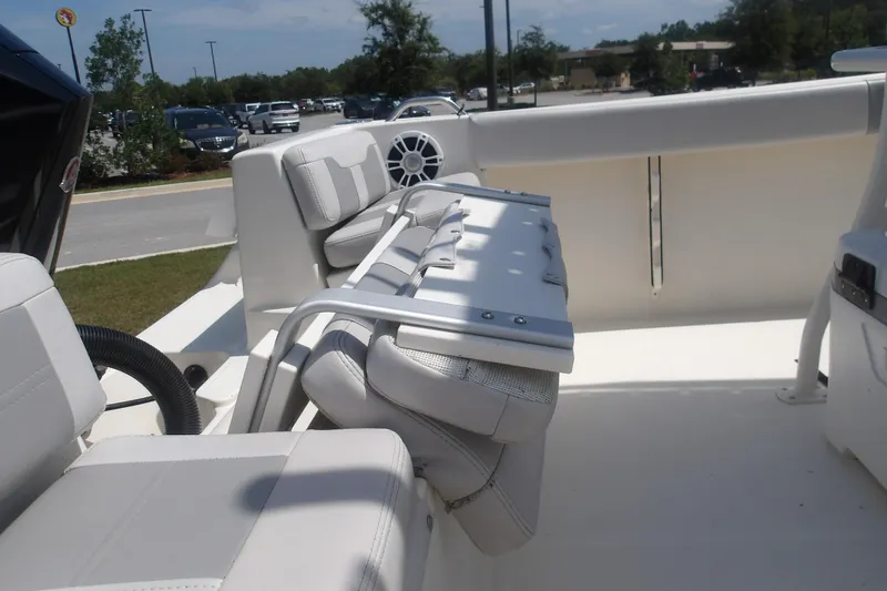 Slide: The Image of 2025 Mako 214 Center Console boat interior with white seating and modern design. - 10