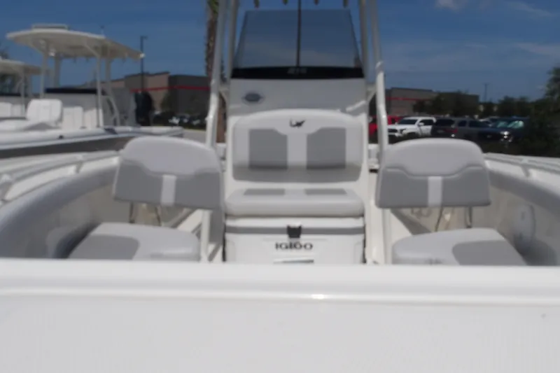 Slide: The Image of 2025 Mako 214 Center Console boat interior with seating and console view. - 12
