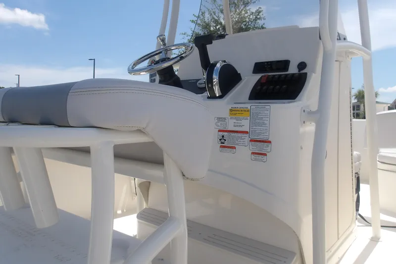 Slide: The Image of 2025 Mako 214 Center Console boat interior with steering wheel and controls. - 9