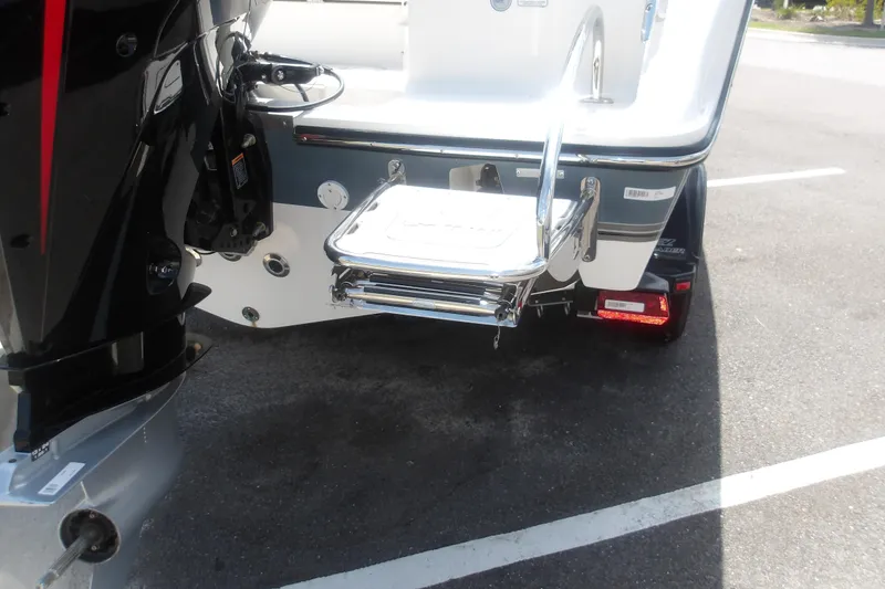Slide: The Image of Rear view of 2025 Mako 214 Center Console boat with swim platform and ladder. - 8