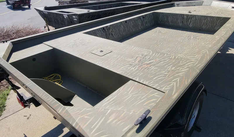 Slide: The Image of 2025 Tracker Grizzly 1754 Jon boat with camouflage pattern on a trailer. - 3