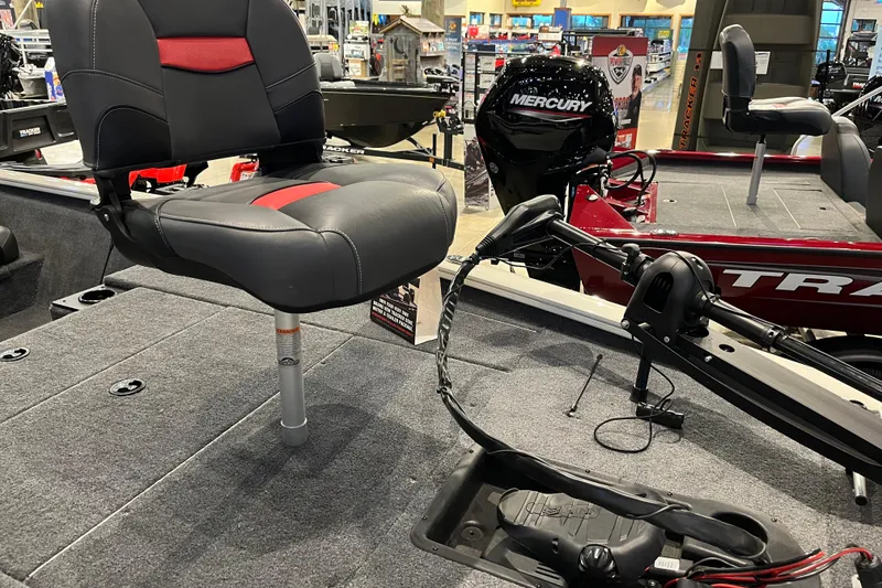 Slide: The Image of 2025 Tracker Pro Team 195 Tournament Edition boat interior with seating and Mercury engine. - 2