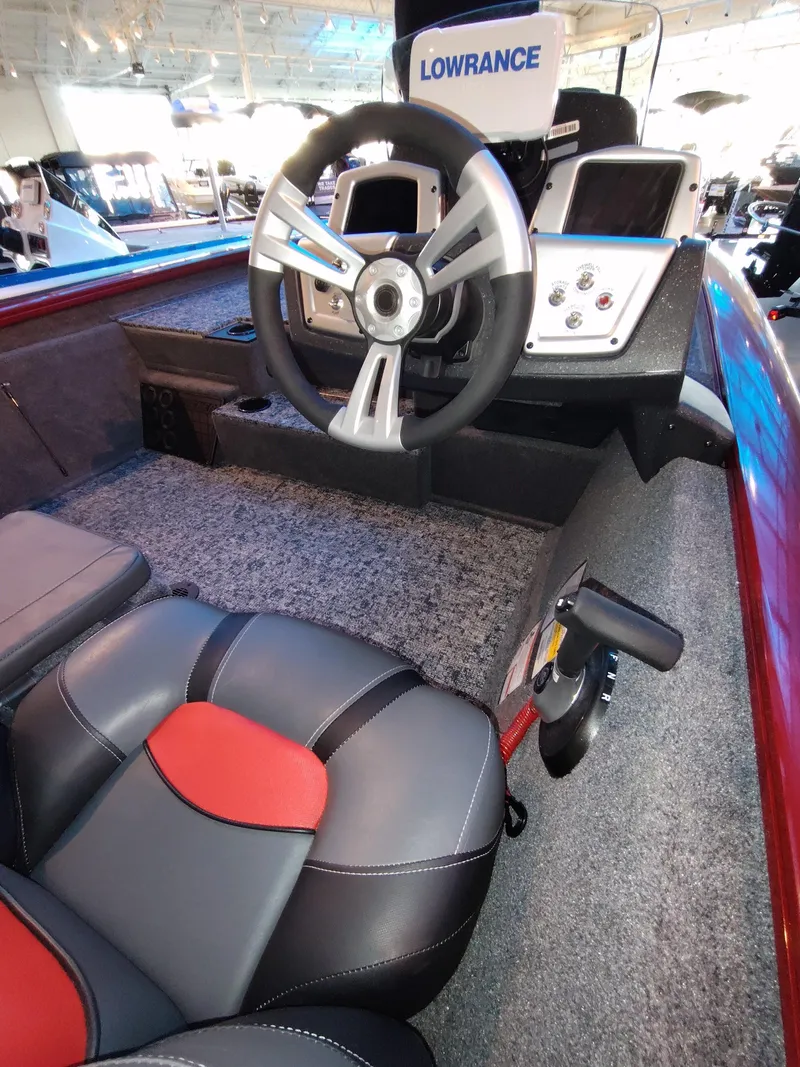 Slide: The Image of 2025 Tracker Pro Team 195 Tournament Edition boat interior with steering wheel and seating. - 2