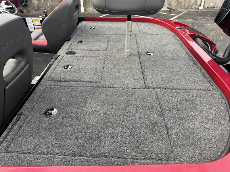 Slide: The Image of 2025 Nitro Z19 boat deck with gray carpet and storage compartments. - 4