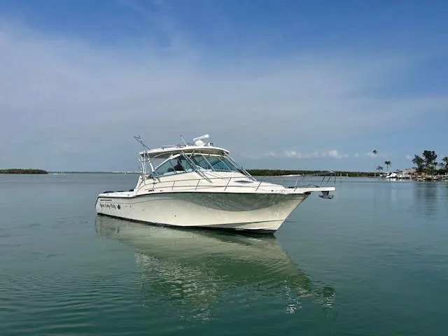 Slide: The Image of 2008 Grady-White Express 360 boat on calm water under clear blue sky. - 2
