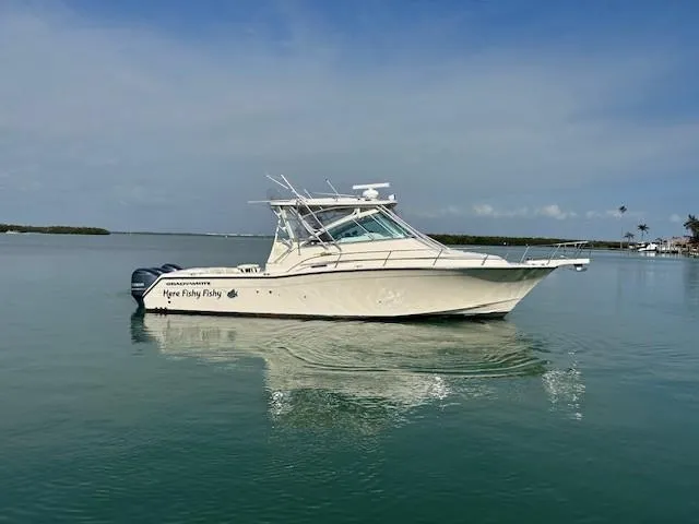 Slide: The Image of 2008 Grady-White Express 360 boat on calm water under clear sky. - 3