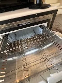Slide: The Image of Open stainless steel oven inside a 2008 Grady-White Express 360 boat. - 35