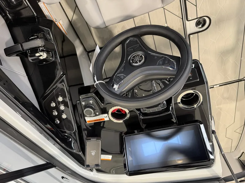 Slide: The Image of 2025 Yamaha Boats 255XD dashboard with steering wheel and touchscreen display. - 5