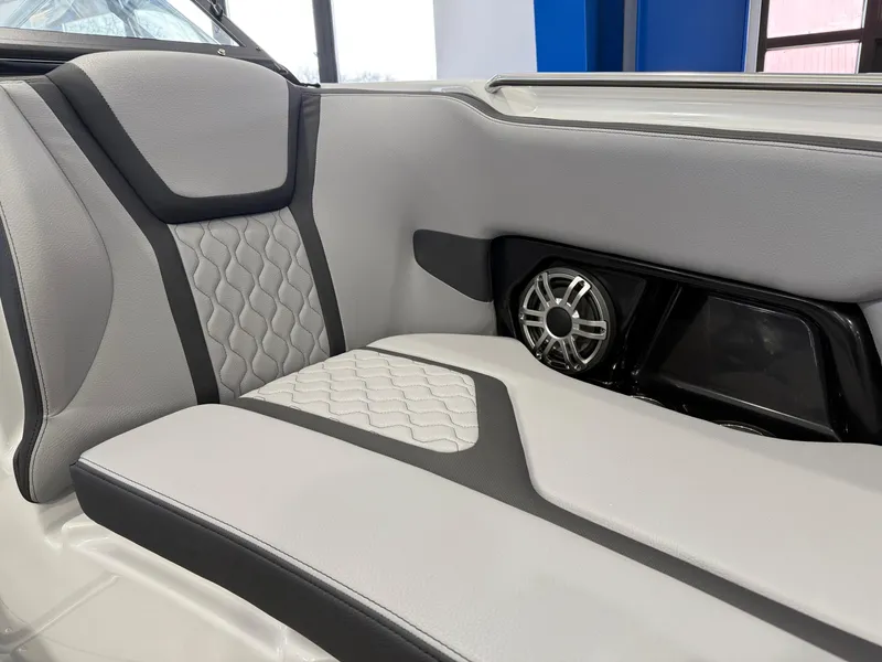 Slide: The Image of 2025 Yamaha Boats 255XD interior with stylish seating and integrated speaker system. - 8