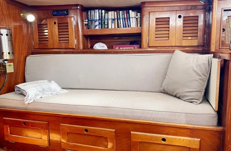 Slide: The Image of Interior of 1981 Bristol 40 sloop with wooden cabinetry and cushioned seating. - 14