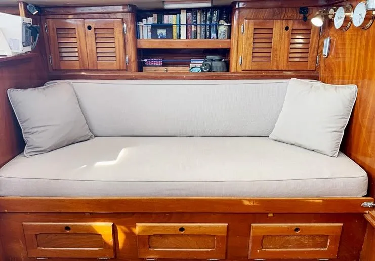 Slide: The Image of Interior of 1981 Bristol 40 sloop with cushioned seating and wooden cabinetry. - 15
