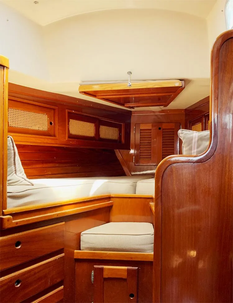 Slide: The Image of 1981 Bristol 40 Sloop interior with wooden finish and cozy seating area. - 16