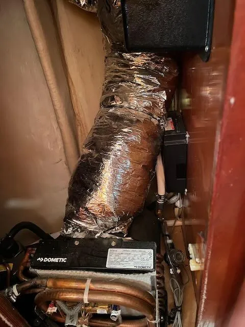 Slide: The Image of Engine compartment of a 1981 Bristol 40 sloop with visible ductwork and components. - 25