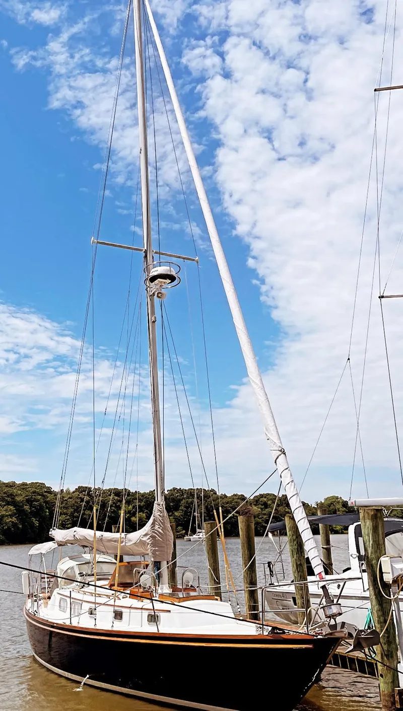 Slide: The Image of 1981 Bristol 40 sloop docked under a partly cloudy sky. - 3