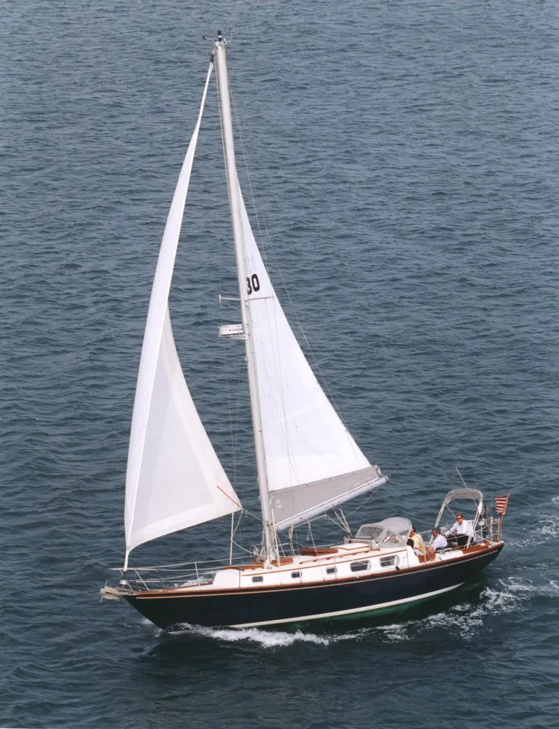 Slide: The Image of 1981 Bristol 40 sloop sailing on open water with full sails. - 37