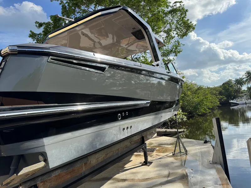 Slide: The Image of 2022 Aviara AV36 OB boat on a dock, surrounded by trees and a river. - 10